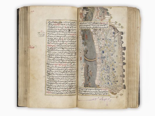 A book containing text on one side and a map of Baghdad on the other side