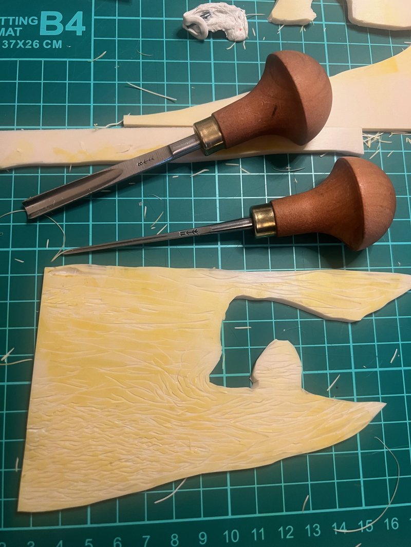 Lino cutting tools on a cutting mat