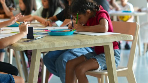 Group of kids sitting and drawing