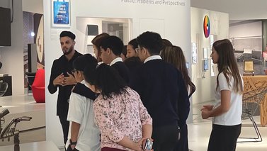 Tour guide giving a tour to a group of students