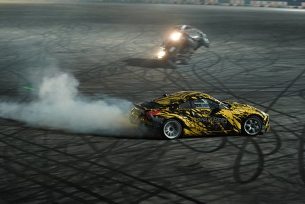 Two race cars free-style drifting in a circut