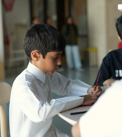 Boy sitting and drawing something