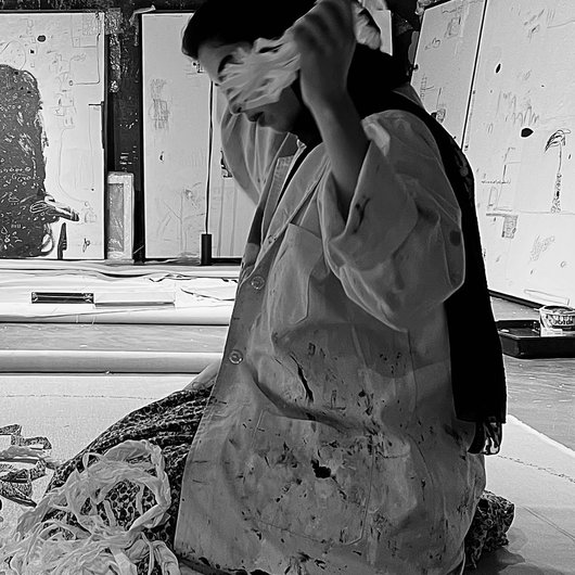 Artist kneeling in an art studio