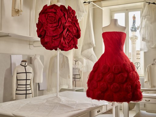 Two red Valentino dresses placed on mannequins in the Valentino workroom.