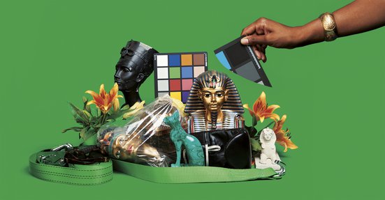 An assemblage of Egyptian themed objects set against a green background.