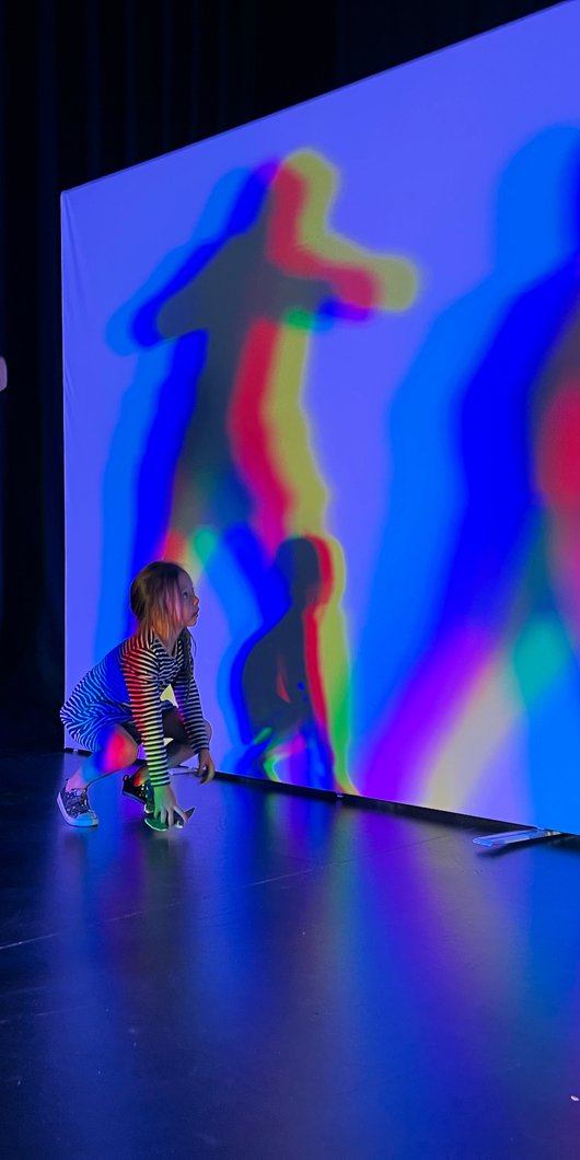 Children playing with LED lights to create shadows