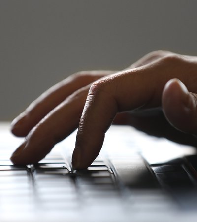 A close-up view of a hand typing on a keyboard