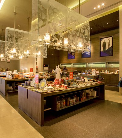 Interior view of MIA's gift shop with a Qatari man purchasing items at the service counter