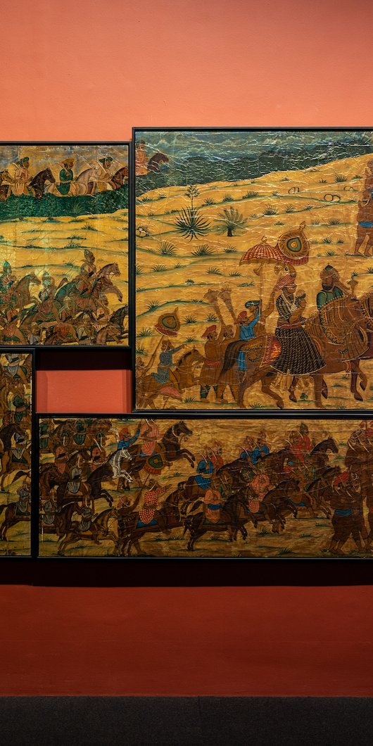 Eight paintings connected together, depicting war times at 'One Tiger or Another' exhibition