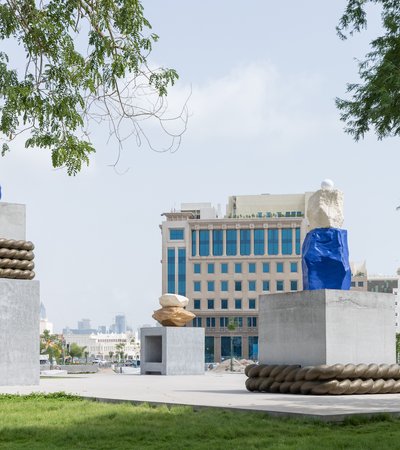 two large sculptures in blue and grey with ropes wrapped around