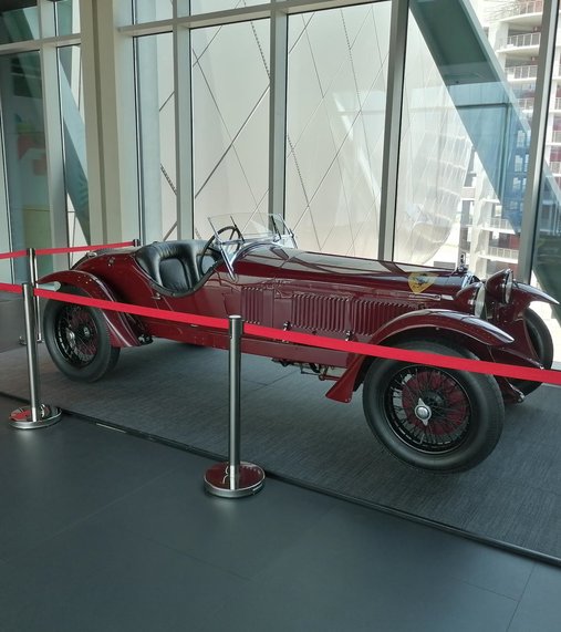 Red Scuderia Ferrari 1933 displayed in a museum space