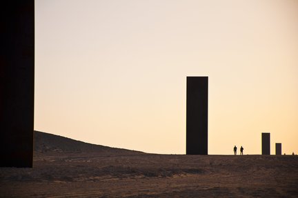 A wide shot of Richard Serra's East-West-West-East at sunset