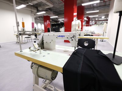 Interior, Cutting Studio, close view of sewing machine with dark fabric