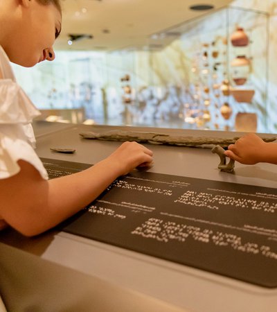 Children using accessible tactile information panels at NMoQ