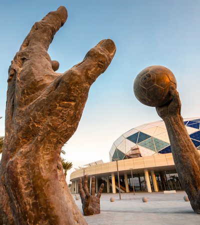 Lifesize installation showcasing bronze sculpted hands playing handball